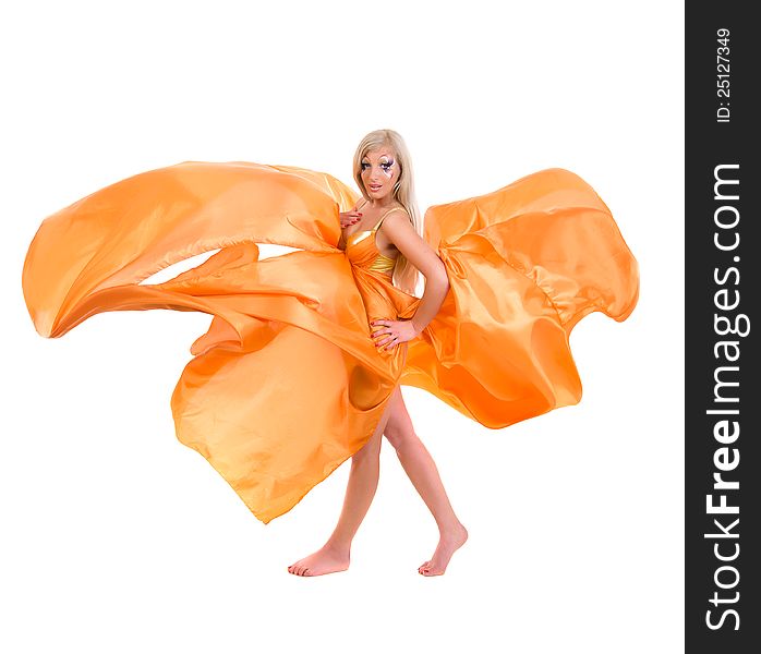 Girl in a flying orange fabric on a white background