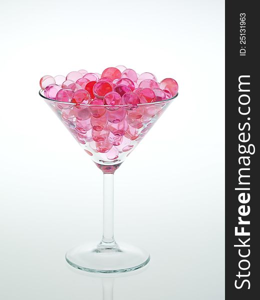 Transparent pink glass beads with white background