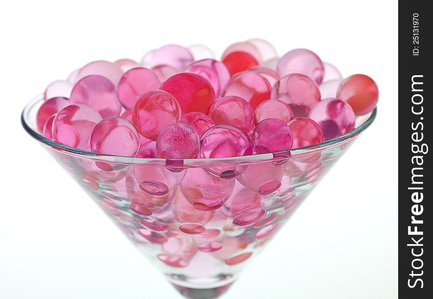 Transparent pink glass beads with white background