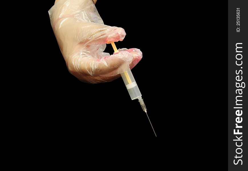 Syringe in hand with gloves. Syringe in hand with gloves