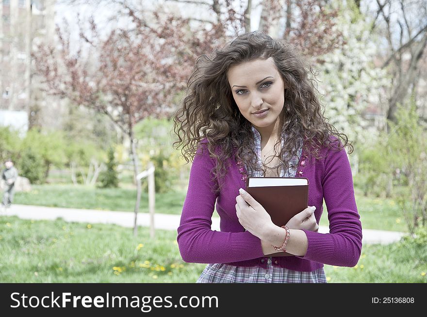 Young Student In Park With Book