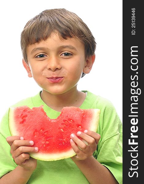 Cute little boy takes a big bite from a slice of watermelon. Cute little boy takes a big bite from a slice of watermelon