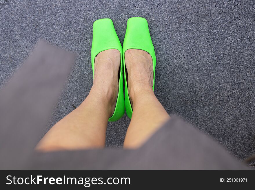 Bright green shoes on women s feet.