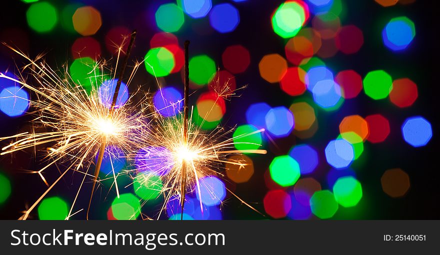 Two bengal lights on colorful background