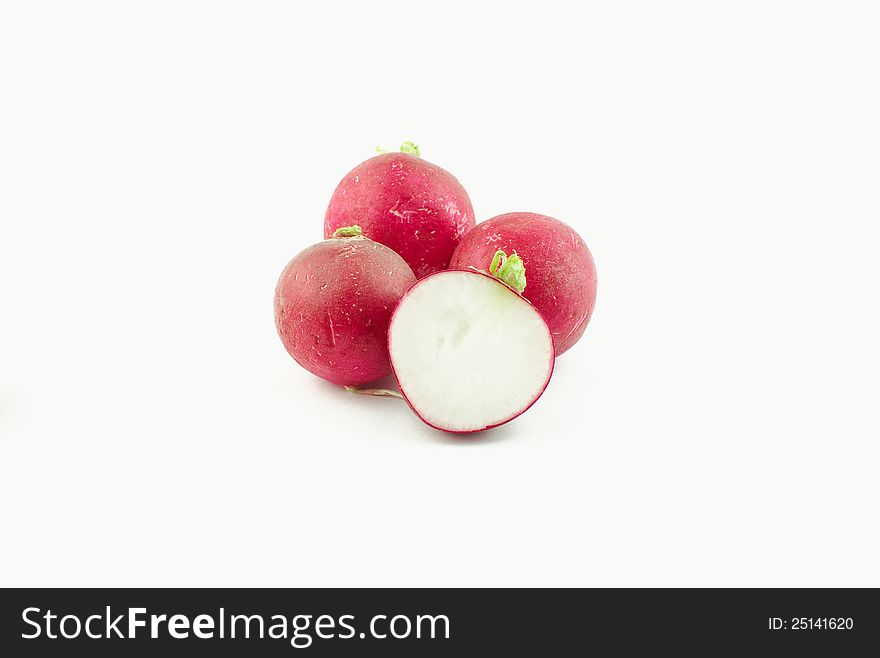 Few radishes and a half on white background