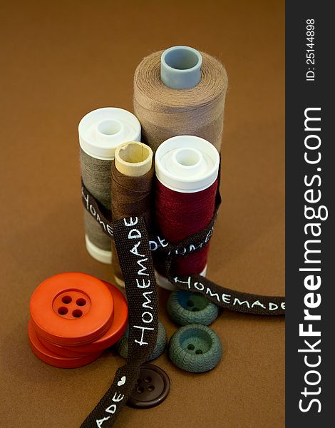Sewing thread and buttons in various colors and ribbon. Sewing thread and buttons in various colors and ribbon