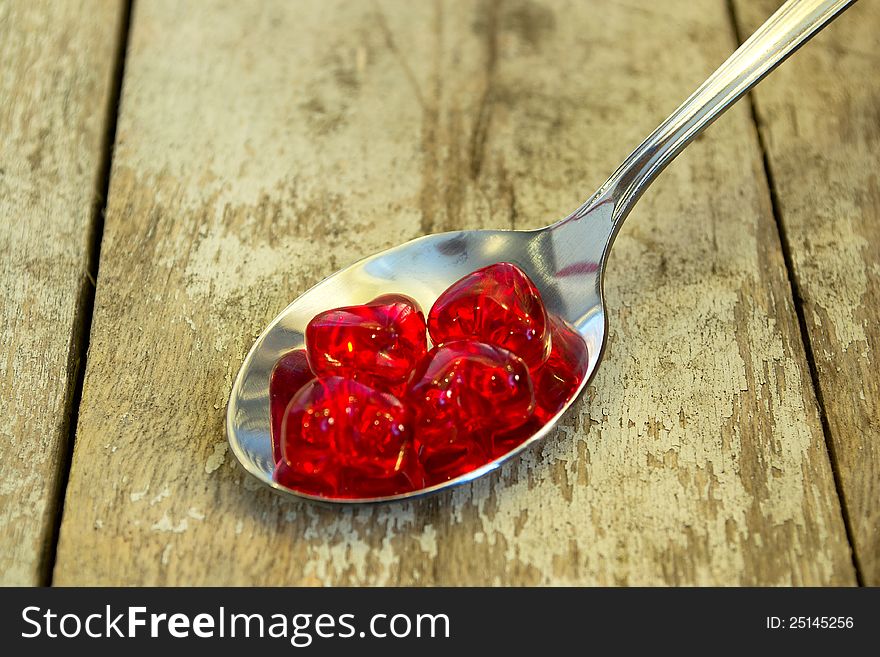 Spoon full of love, background an old garden furniture. Spoon full of love, background an old garden furniture