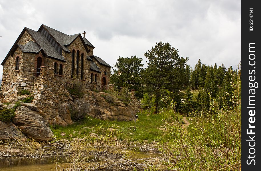 A rustic stone church under a grey cloudy sky. A rustic stone church under a grey cloudy sky.