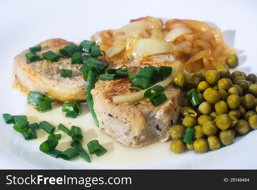 Peace of fringed meat with garnish on white plate. Barbecue