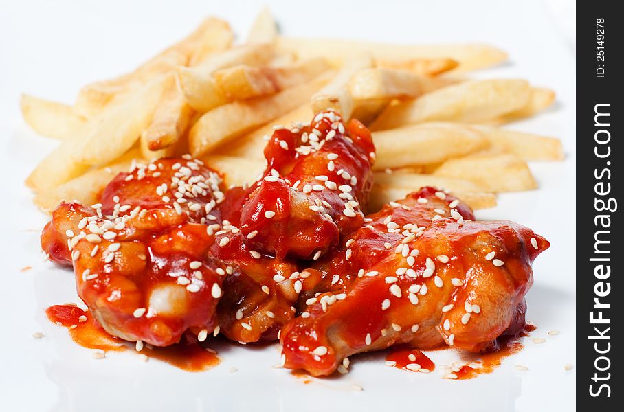 French Fries And Chicken In Tomato Sauce