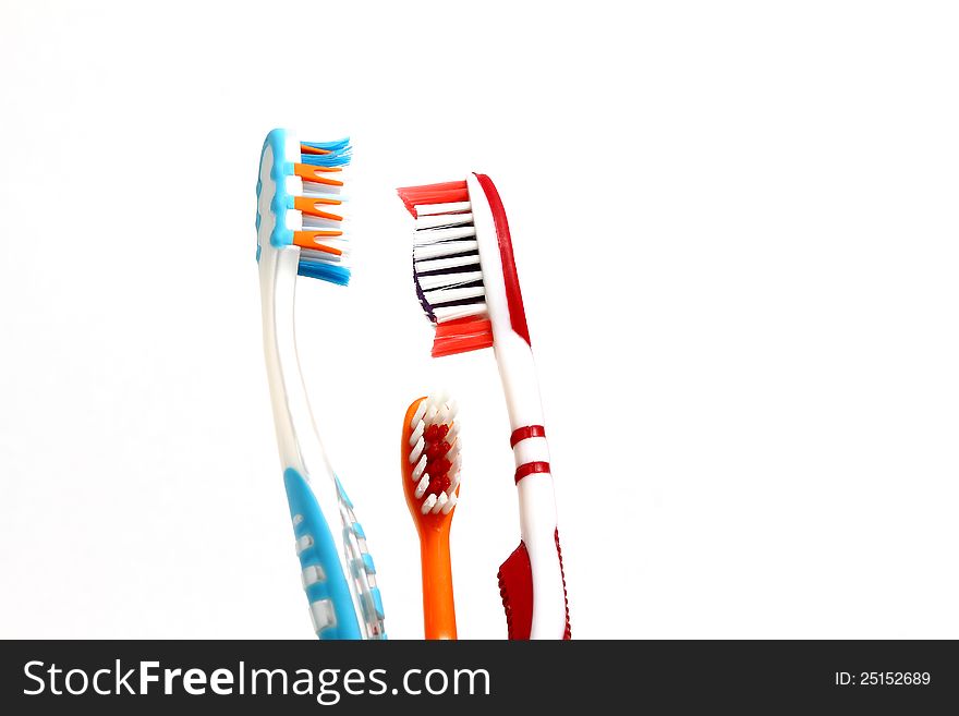 Two adult toothbruses and a kid toothbrush