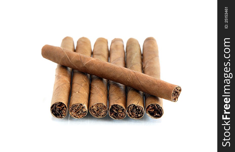 Few cigars in a row on white background. Few cigars in a row on white background