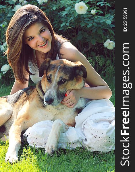 Happy and smiling teenager with her dog . Natural light portrait and smile with braces.