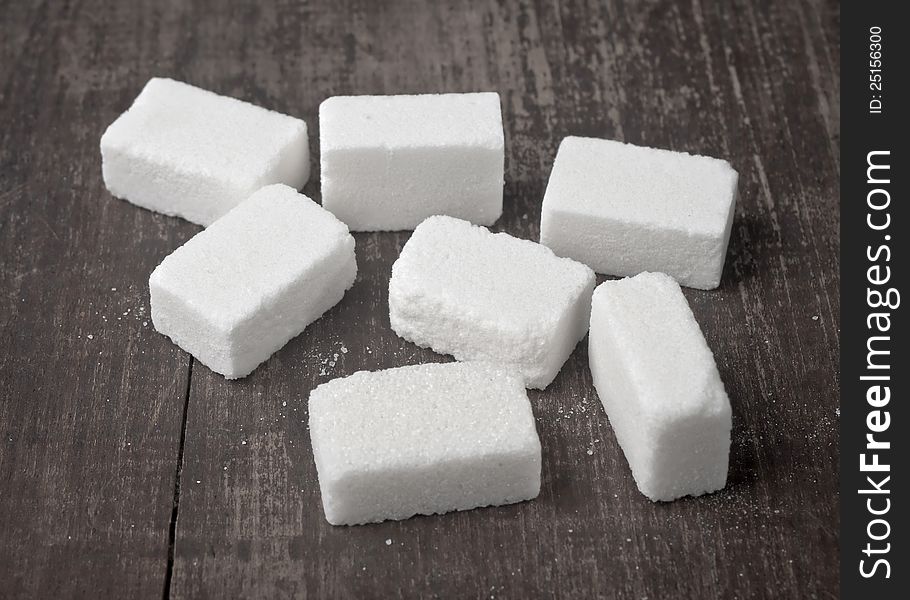 Sugar Cubes on wooden table