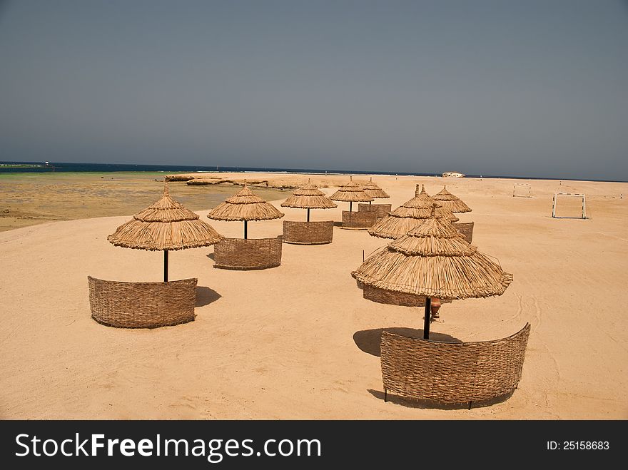 Straw umbrellas on sandy beach in arestort in red sea, Egypt. Straw umbrellas on sandy beach in arestort in red sea, Egypt