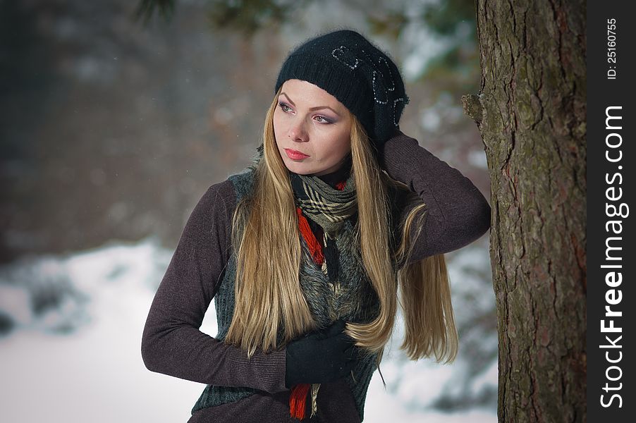 Blonde Girl With Black Cap Play In Winter Snow