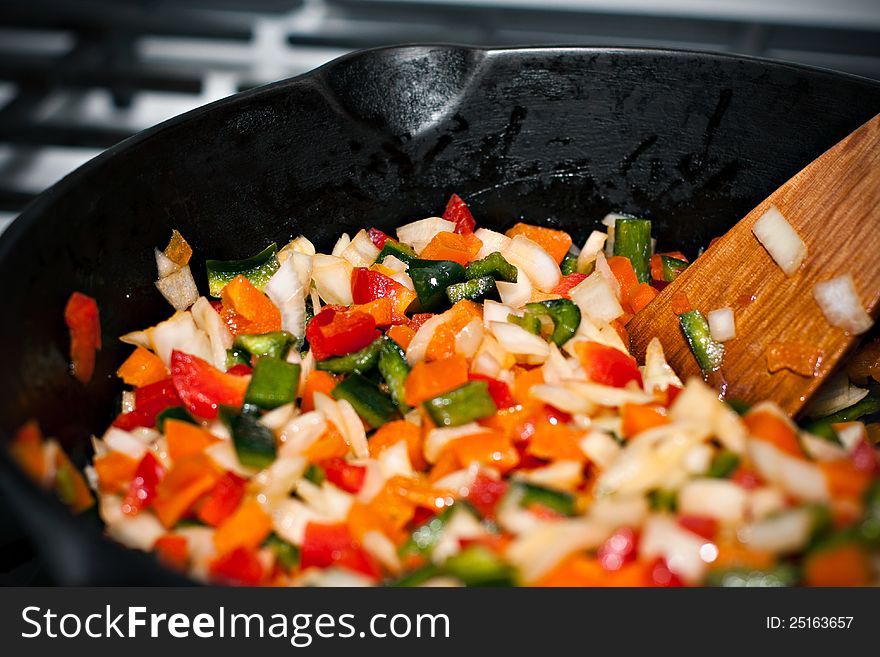 A seasoned arrangement of colorful bell peppers sauteed in a pan. A seasoned arrangement of colorful bell peppers sauteed in a pan.