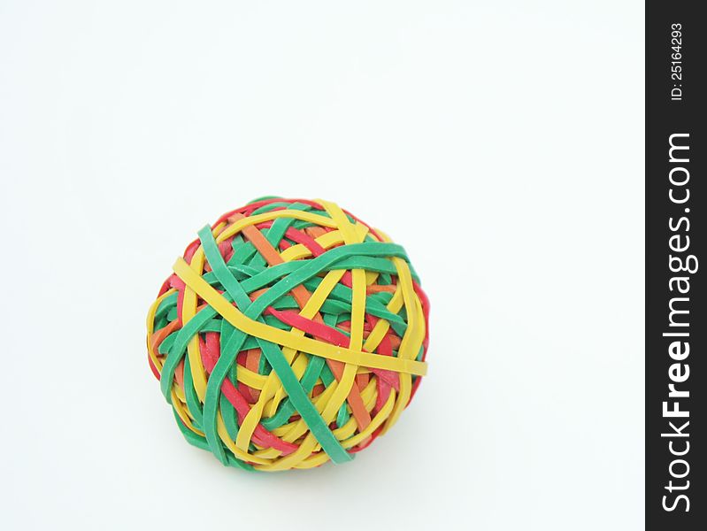 Ball of colored rubberbands on white
