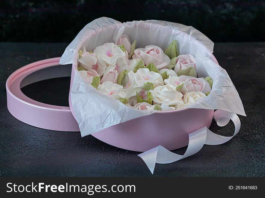 homemade marshmallows in a gift box on a dark background, a beautiful delicate bouquet of marshmallow flowers, holiday concept, gi