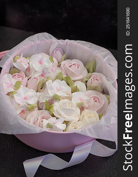 homemade marshmallows in a gift box on a dark background, a beautiful delicate bouquet of marshmallow flowers, holiday concept, gifts