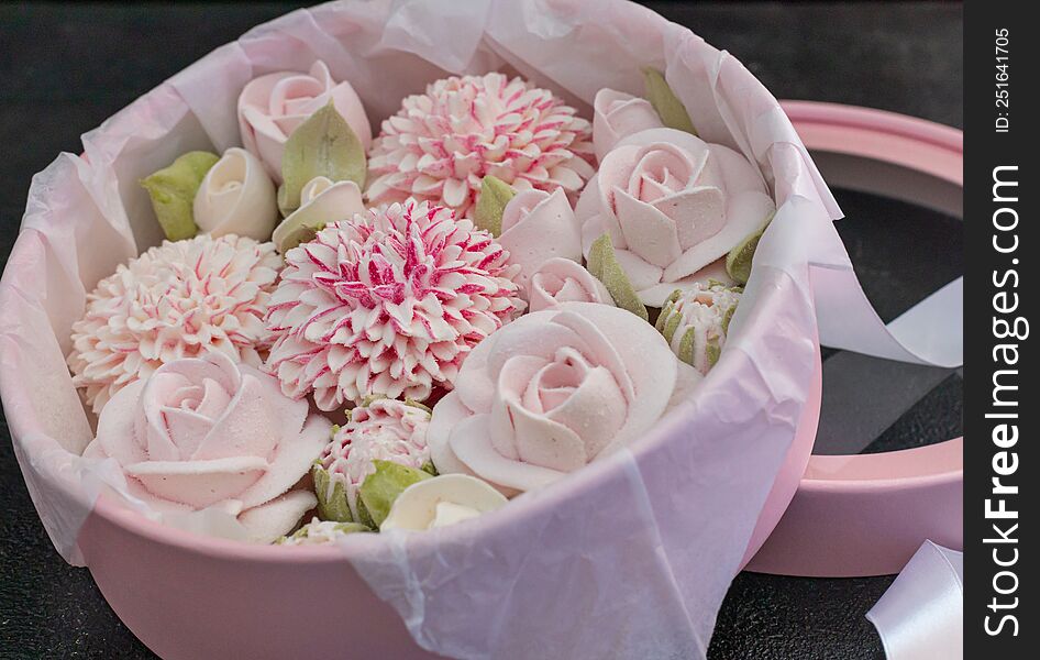 homemade marshmallows in a gift box on a dark background, a beautiful delicate bouquet of marshmallow flowers, holiday concept, gifts