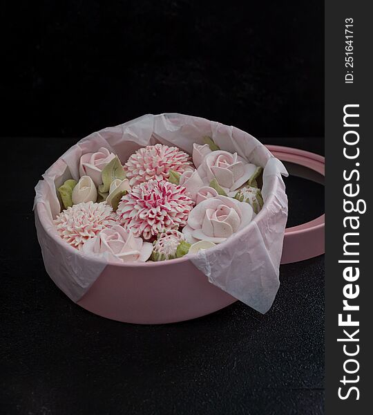 homemade marshmallows in a gift box on a dark background, a beautiful delicate bouquet of marshmallow flowers, holiday concept, gifts