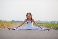 Cute Young Girl Makes A Split On A Path Stock Images