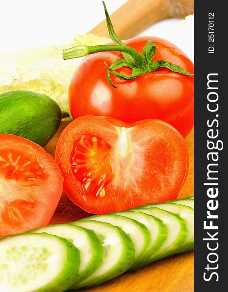 Tomatoes and cucumbers beautifully cut on the Board for the salad