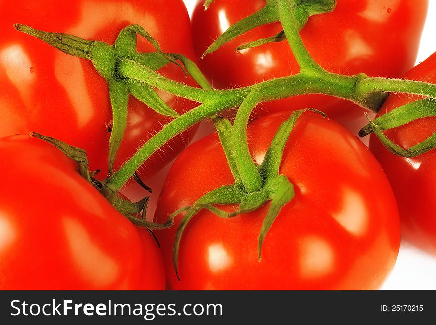 Red tomatoes on a branch, coarsely. Red tomatoes on a branch, coarsely.