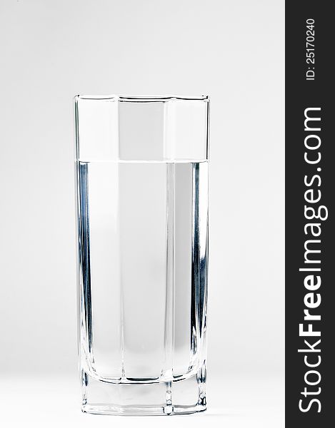 With a glass of clean drinking water on a white background. With a glass of clean drinking water on a white background