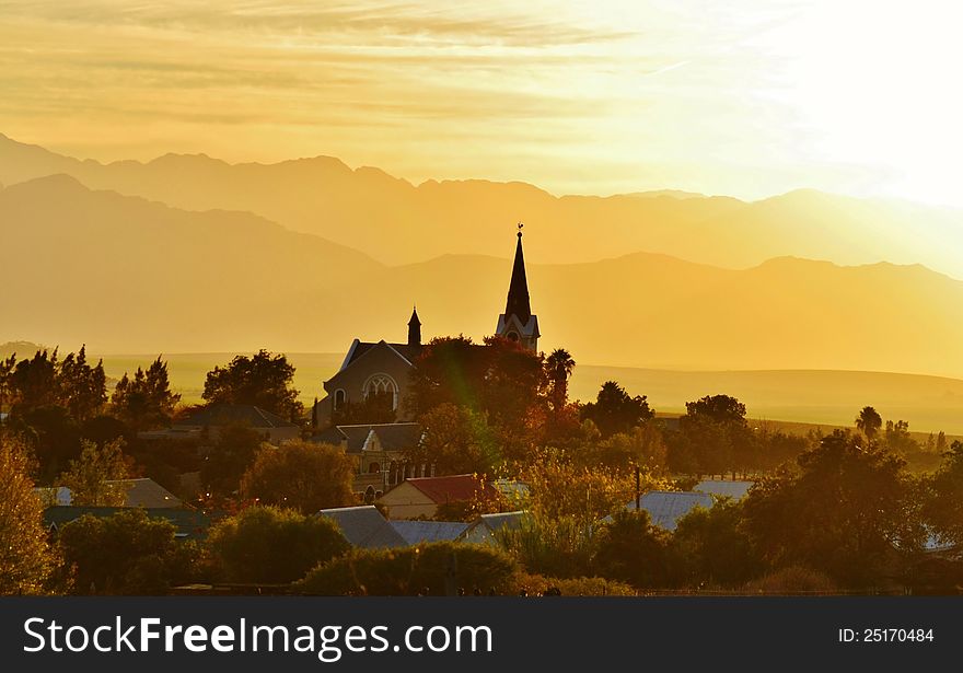 Landscape of Church at dusk with mountains in background