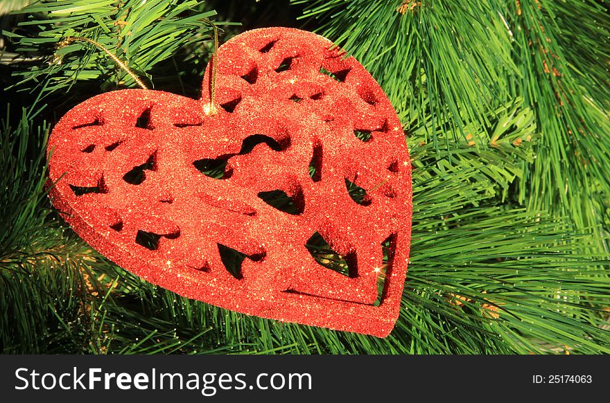 Christmas tree toy in the form of a red heart in close-up