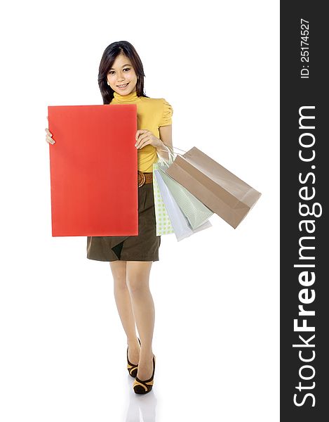 Beautiful woman hold blank red banner isolated over white background. Shopping concept, you can put your message on the banner. Beautiful woman hold blank red banner isolated over white background. Shopping concept, you can put your message on the banner