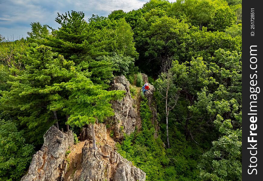 Rocky hill with abundant vegetation. Cedars grow right in the rocky rock. Nature protection zone near Khabarovsk in the Khekhtsir Nature Reserve. The Snake Hill is a favorite place for tourists to take pictures. The photo was taken from a drone.