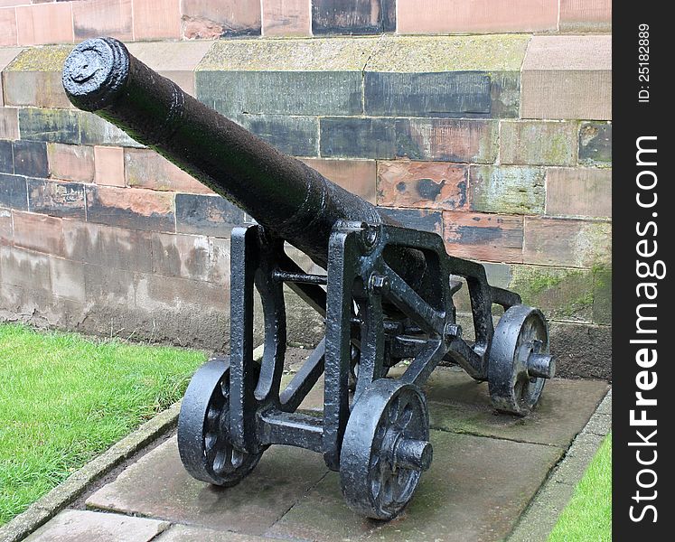 A Vintage Heavy Cannon Outside a Castle Wall. A Vintage Heavy Cannon Outside a Castle Wall.