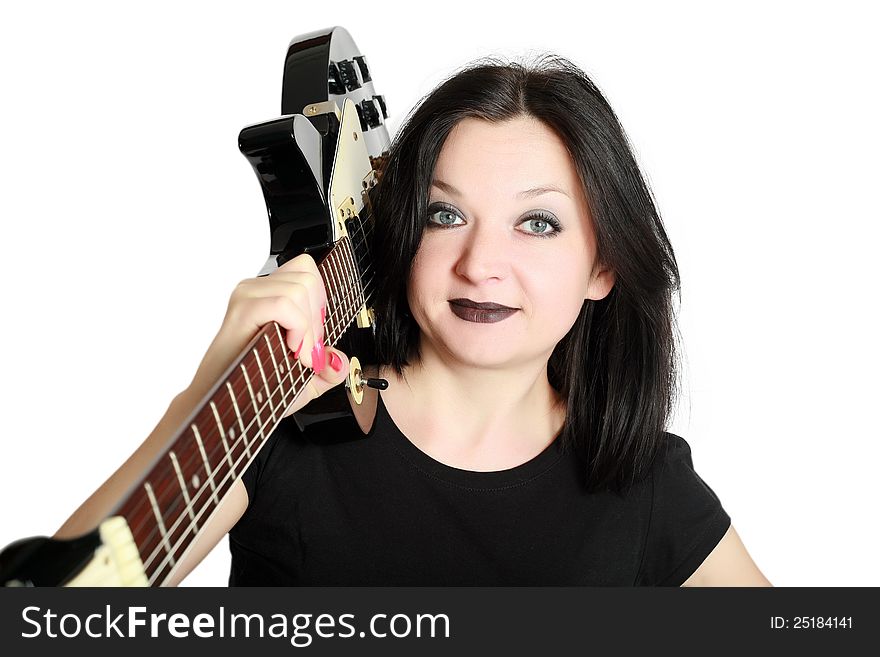 Brunette girl posing with a guitar on his shoulder an isolated