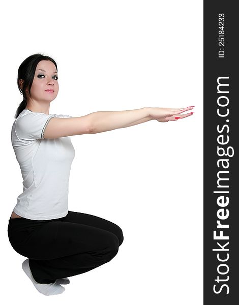 Brunette girl doing exercises on an isolated white background