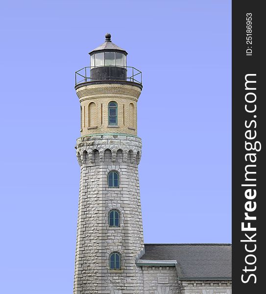 Old stone and brick warning beacon light house.  Isolated against blue. Old stone and brick warning beacon light house.  Isolated against blue.