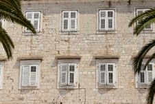 Stony Wall And White Windows Stock Photo