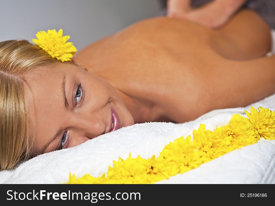 Young blond caucasian woman receiving back massage at Beauty Spa salon. Horisontal. Young blond caucasian woman receiving back massage at Beauty Spa salon. Horisontal