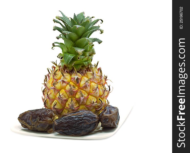 Pineapple and dates isolated on white background. Pineapple and dates isolated on white background