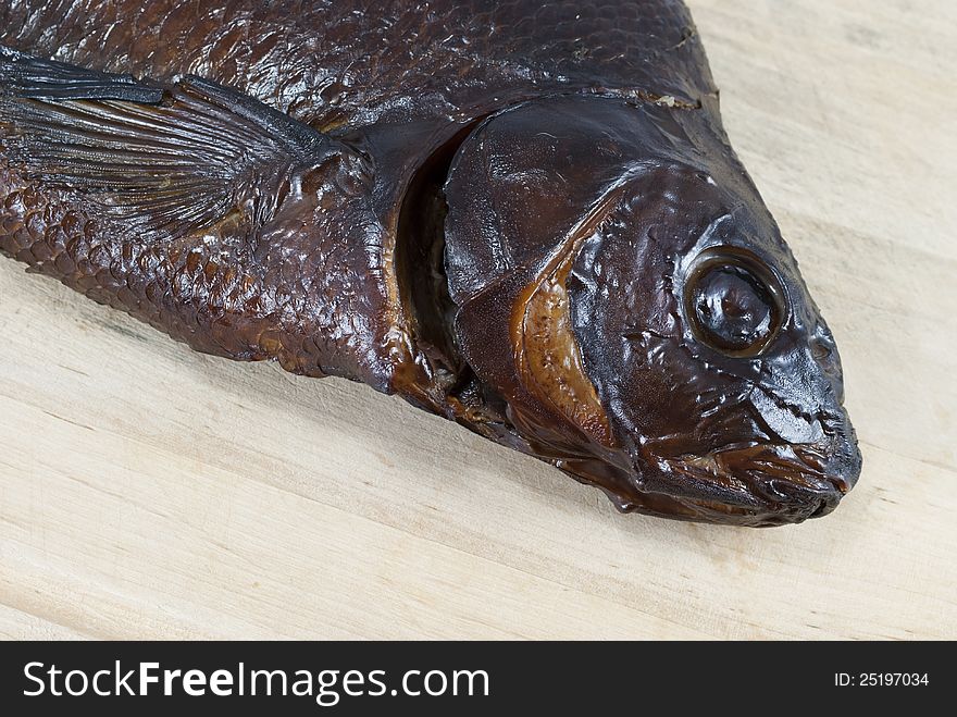 Smoked bream closeup on a wooden board. Smoked bream closeup on a wooden board