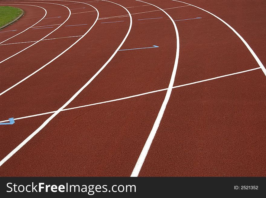 Close-up of a red en white cinder track