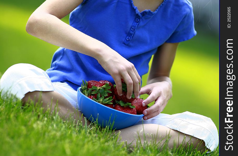 Eating strawberries in the yard in the summer.