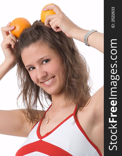 The brown-eyed girl on a white background holds oranges. The brown-eyed girl on a white background holds oranges