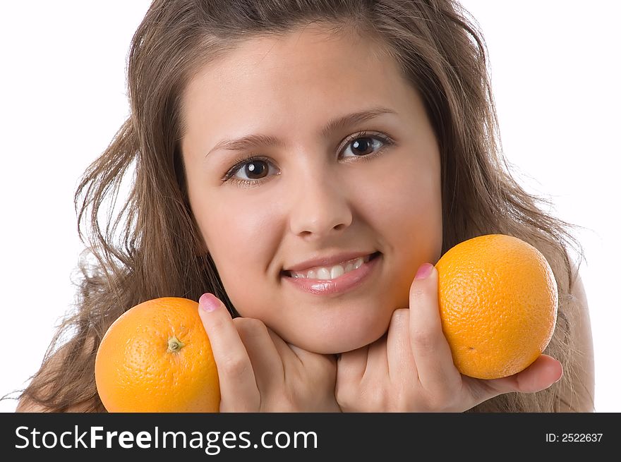 The brown-eyed girl on a white background holds oranges. The brown-eyed girl on a white background holds oranges