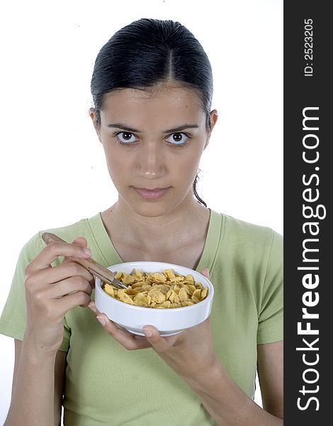 Pretty girl eating cornflakes isolated