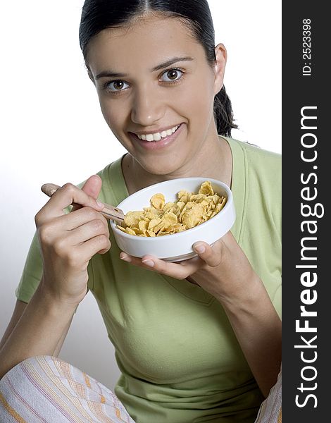 Pretty girl eating cornflakes isolated
