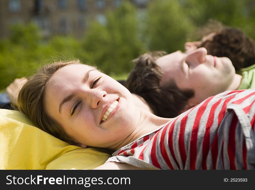 Young girl sunbathing with the friends. Young girl sunbathing with the friends