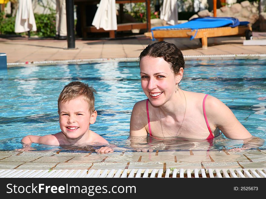 Boy with mother in pool